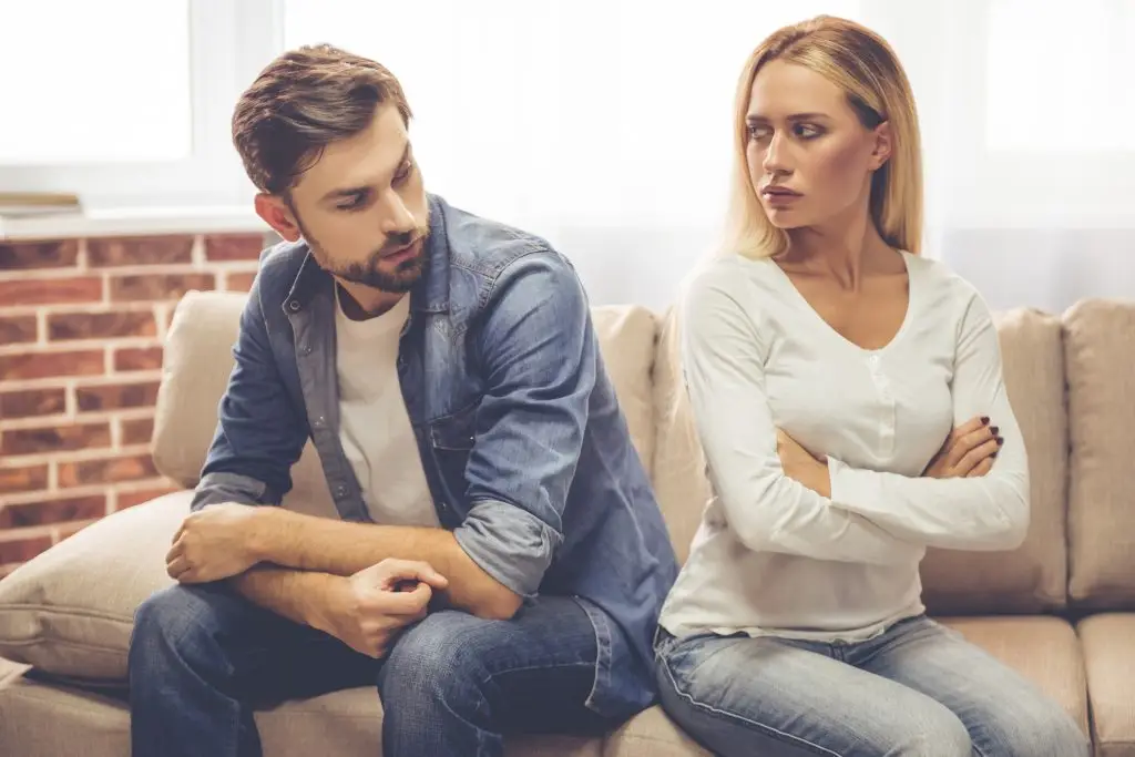 Couple sitting apart during a relationship conflict